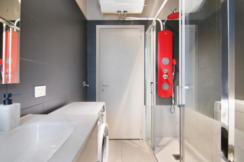 a bathroom with a shower and a white sink at Colico Center in Colico