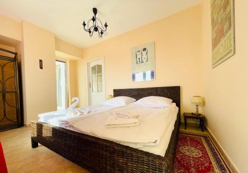 a bedroom with a large bed with white sheets at Chrobry by Baltic Home in Międzyzdroje