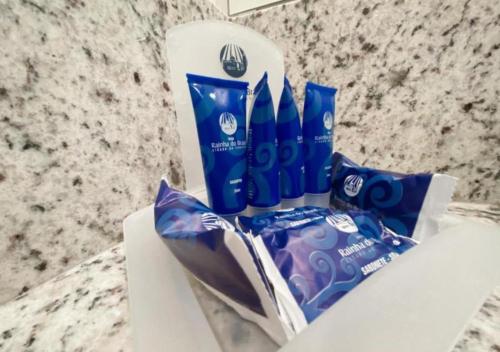 a group of toothpaste and toothbrushes sitting on a counter at Hotel Rainha do Brasil in Aparecida
