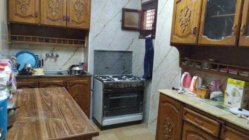 a kitchen with a stove and a sink in it at Ismailia - Elnouras compound in Ismailia