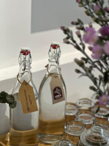 two bottles of alcohol sitting on a table with flowers at Loka Home & Yoga in Da Nang