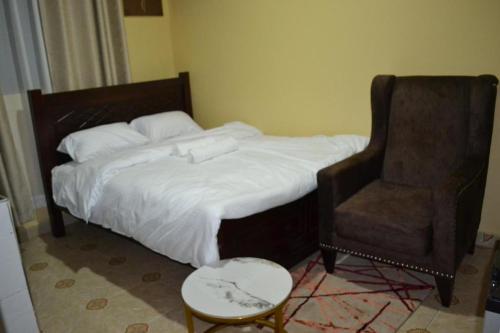 a bed and a chair in a room at ROSEVIEW in Kiambu