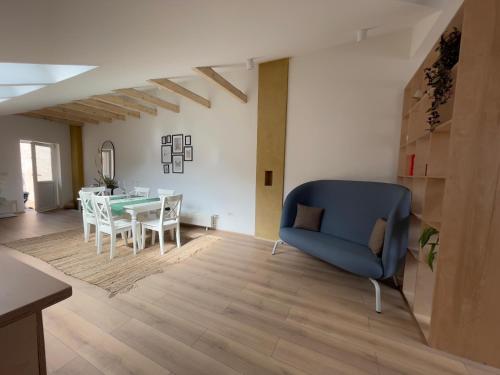 a living room with a blue chair and a table at Fericirii A in Cluj-Napoca