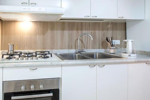 a kitchen with a sink and a stove at Gemma di Zagara Apartment in Sorrento