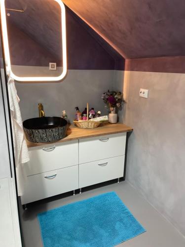 a bathroom with a counter with a sink and a mirror at Fericirii A in Cluj-Napoca