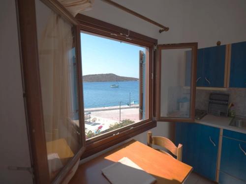 a window in a kitchen with a view of the ocean at Calypso Hotel in Lipsoi