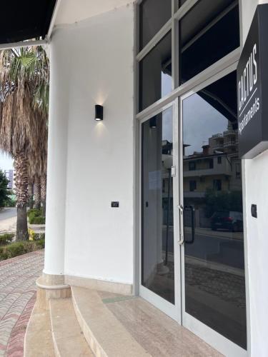 a glass door of a building with a sign on it at Cactus Apartments in Durrës