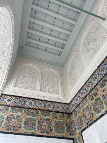 a room with a white ceiling and tiles on the floor at Maison typique de la médina in Tunis