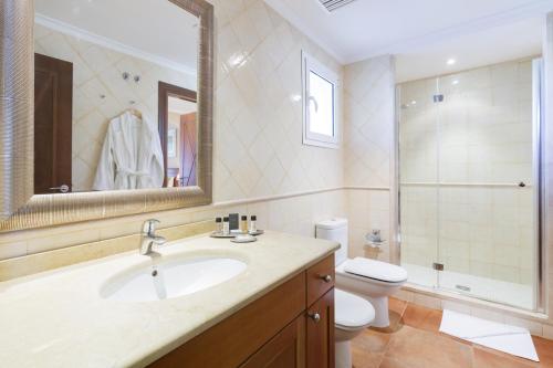 a bathroom with a sink and a toilet and a mirror at LA SELLA PREMIUM lifestyle Apartments in Denia