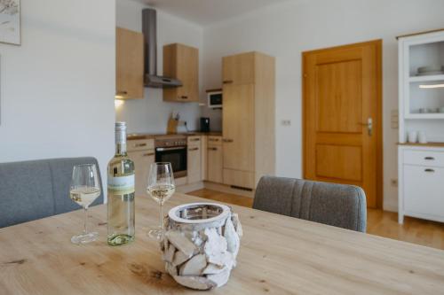 a table with two glasses and a bottle of wine at Villa SEEhnsucht in Jois