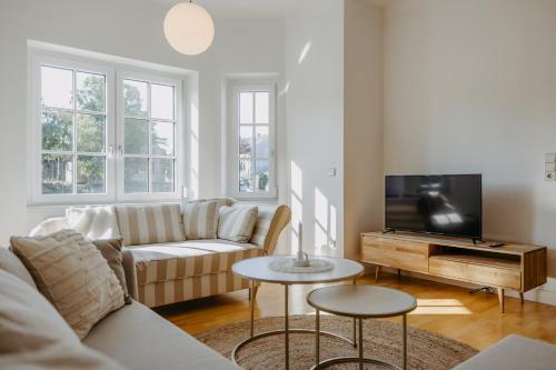 a living room with a couch and a tv at Villa SEEhnsucht in Jois