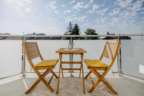 two chairs and a table on a balcony at Villa SEEhnsucht in Jois