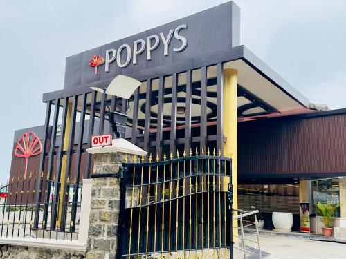 a store front with a popeyes sign on it at Poppys Pleasant Stay in Kodaikānāl