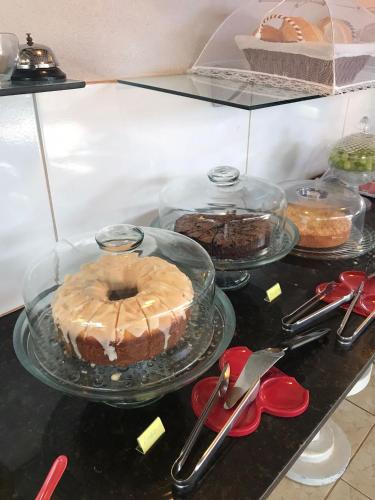 a table with a cake and other desserts on display at AYRE GOSTOSO POUSADA in São Miguel do Gostoso