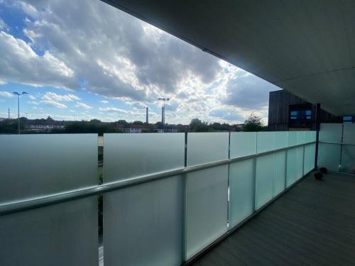 a balcony with a view of the water on a building at Stunning 2 Bedroom Apartment in Croydon