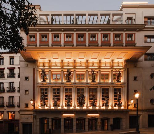 a large building with a lit up facade at UMusic Hotel Madrid in Madrid