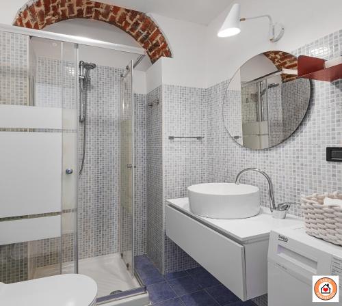 a white bathroom with a shower and a sink at Nido Milanese - Bocconi, Navigli, Duomo in Milan
