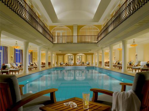 a pool in a hotel with tables and chairs at Terelj Hotel & Spa in Ulaanbaatar