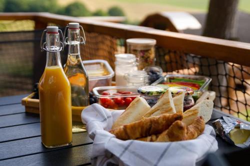 a table with a basket of bread and bottles of beer at Diamond Cabin Orava in Párnica