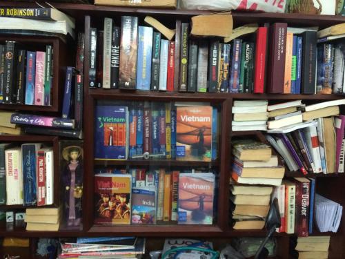 a book shelf filled with lots of books at Diep Anh Guest House in Ho Chi Minh City
