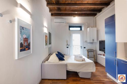 a bedroom with a bed in a room with white walls at Nido Milanese - Bocconi, Navigli, Duomo in Milan