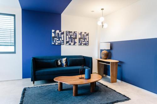 a living room with a blue couch and a table at Exklusive Design Appartement Deep Blue Neubau in Pfungstadt