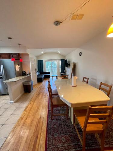 a kitchen and living room with a table and chairs at Business & Family Friendly Balcony Jacuzzi Free Park in Jersey City