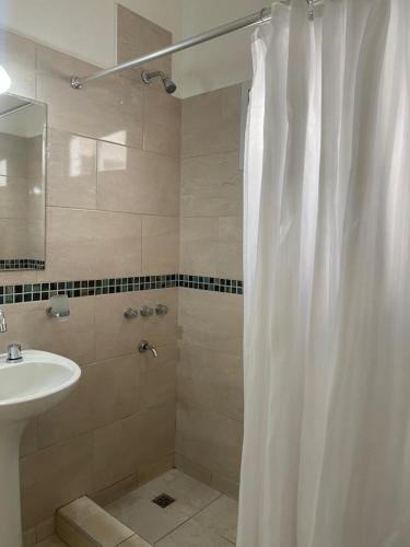 a bathroom with a shower curtain and a sink at CASA ALQUILER TEMPORAL VILLA CABRERA in Córdoba