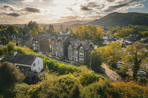 a town in the mountains with houses and trees at Ambleside Townhouse in Ambleside