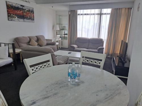 a living room with a table with two bottles on it at Vacation Suites at Times Square KL in Kuala Lumpur