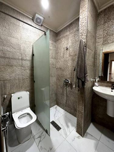 a bathroom with a shower and a toilet and a sink at Downtown Gem: Rabat Hassan in Rabat