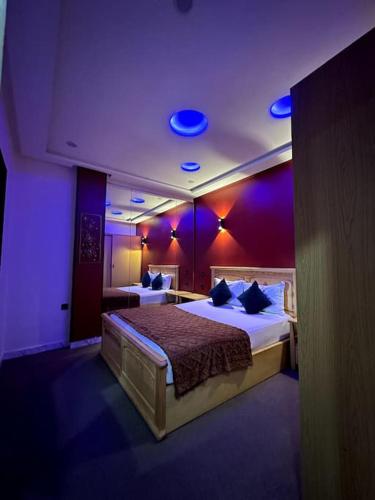 a bedroom with two beds with purple lights at Downtown Gem: Rabat Hassan in Rabat
