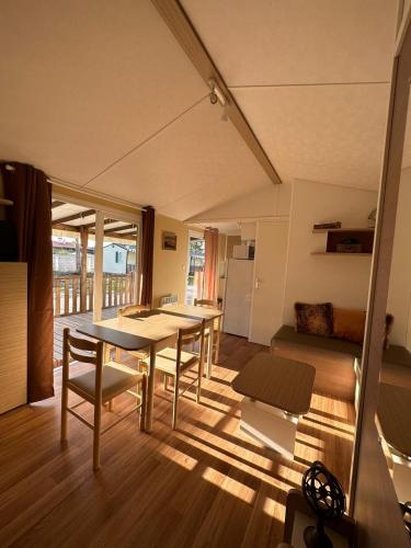 a living room with a table and chairs and a couch at Surya's Bungalow in Pataias