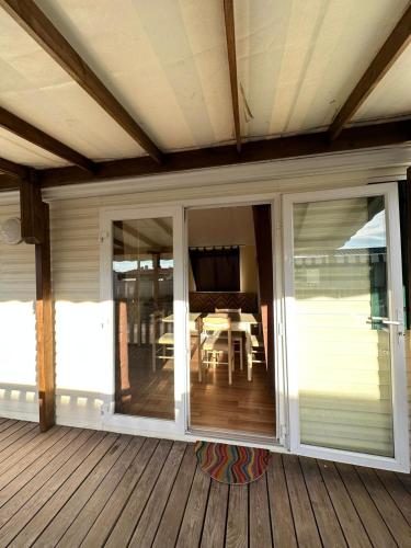 a porch with sliding glass doors on a deck at Surya's Bungalow in Pataias