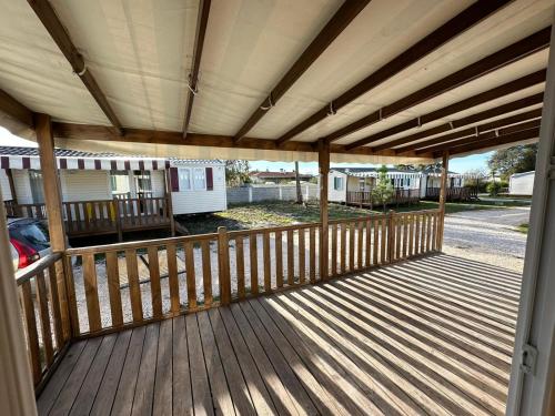 a wooden deck with awning on a house at Surya's Bungalow in Pataias