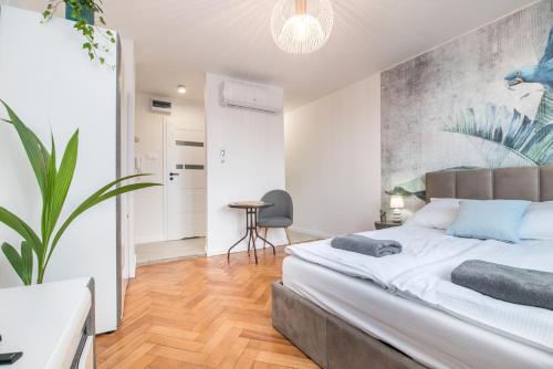 a bedroom with a large bed and a table at Apartament Dworcowa 24 in Gliwice