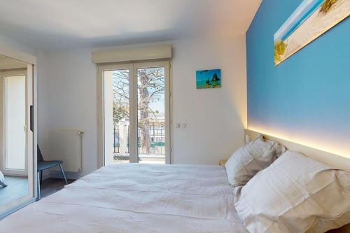 a bedroom with a large bed with a blue wall at 11.Studio#Creteil#Loft#Cinéma in Créteil