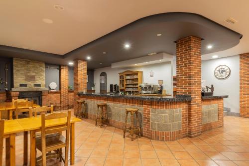 a large kitchen with a brick island in a room at Hotel Rural Rio Viejo in Cubillas de Arbas