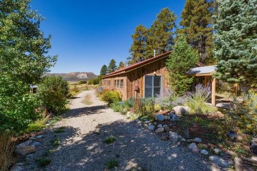 a path leading to a cabin in the woods at 3076 W Highway 160 - Combo in Mancos