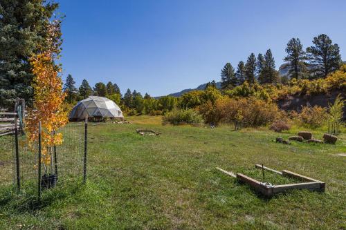 a large field with a tent in the background at 3076 W Highway 160 - Combo in Mancos