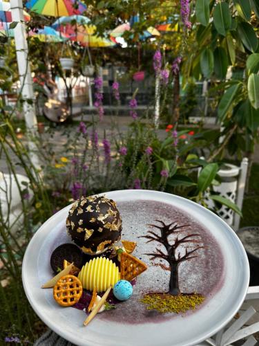 a plate of food with cookies and a tree on it at Qafqaz Fountain Villa in Gabala