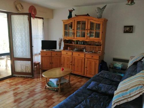 un salon avec un canapé et une table dans l'établissement Appartement 4/6 Personnes Plain Pied - 5min Plage - Piscine en face, au Cap d'Agde