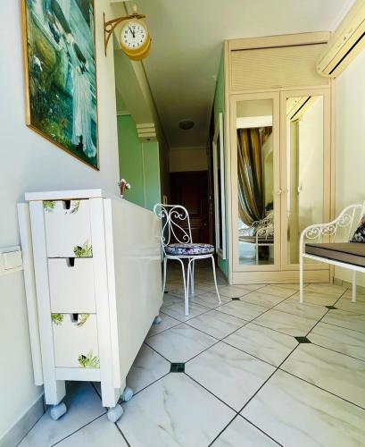 a room with a dresser and a clock on the wall at Wisteria in Nafpaktos