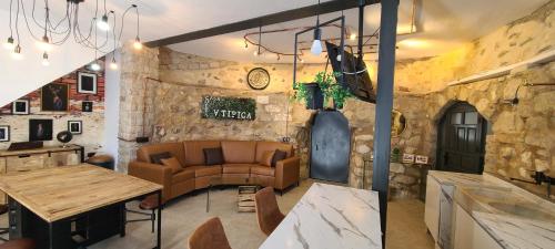 a living room with a couch and a table at CASA CUEVA A-TIPICA in Pegalajar