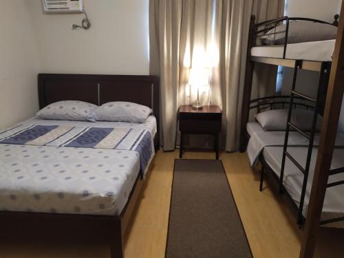 Krevet ili kreveti u jedinici u okviru objekta Mactan Airport Guesthouse