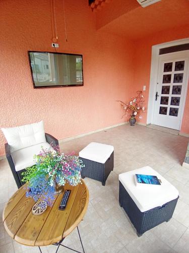 a living room with a table and a couch at HAUT VILLA MESANGES EN BORD DE MER ! in Lucciana