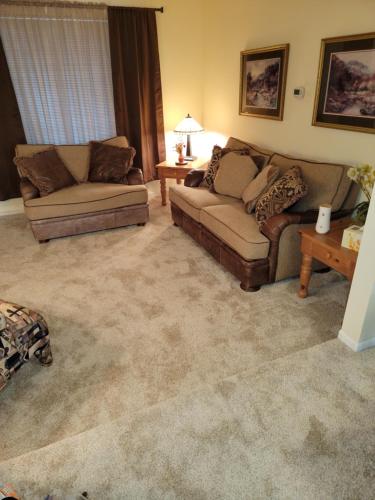 a living room with two couches and a table at 3Br 2Ba Charming gem near shops, restaurants, and hospitals in Albuquerque