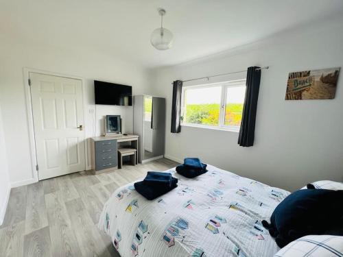 a bedroom with a bed with blue pillows on it at 2 bedroom holiday home in the heart of west wales in St Clears