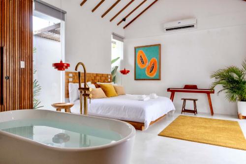 a bedroom with a bed and a bath tub at Manao Villas - Luxury Boutique Resort in General Luna