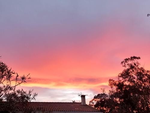 a cross on top of a house with a sunset at HAUT VILLA MESANGES EN BORD DE MER ! in Lucciana
